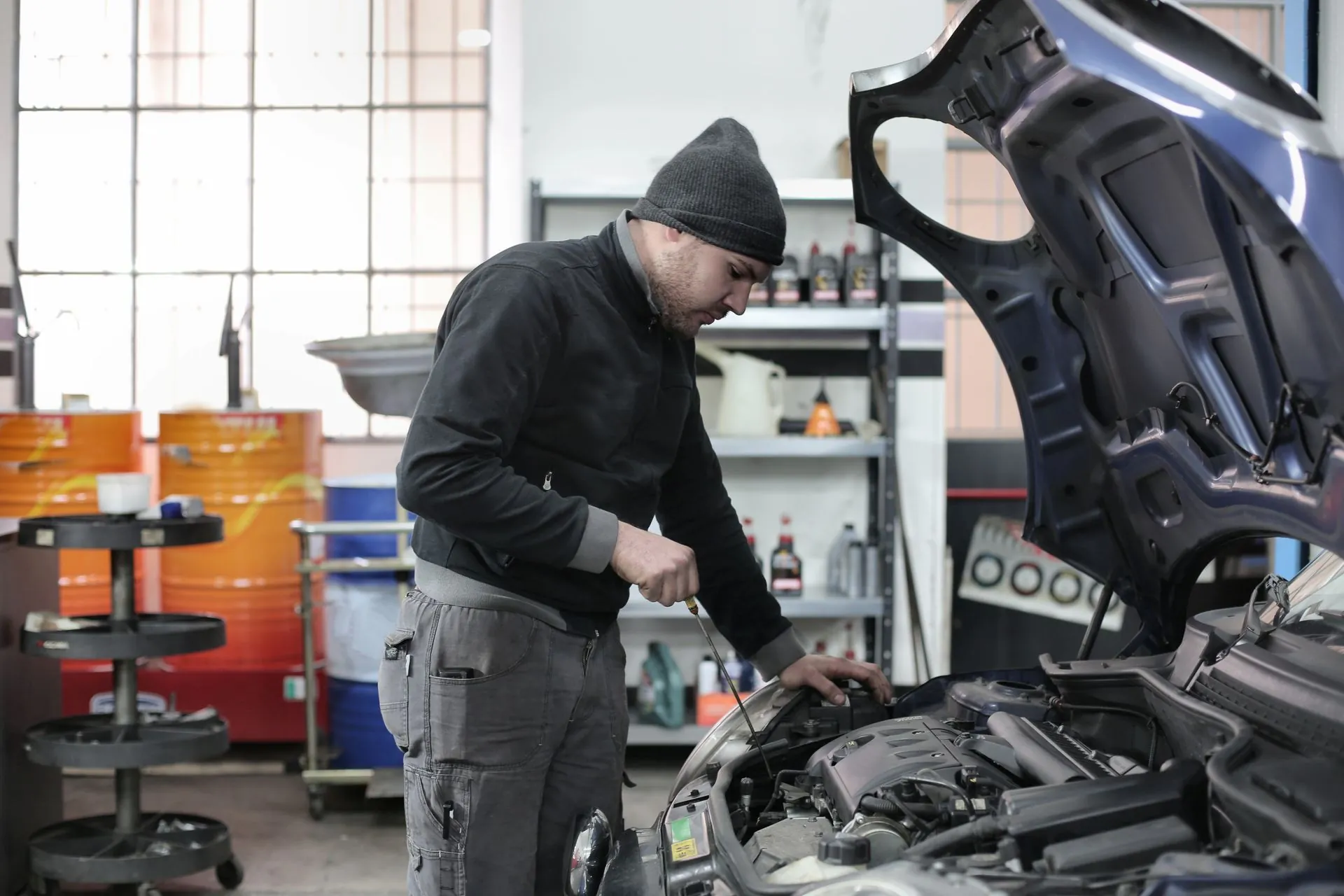 Car mechanic working on an engine in a workshop (representative image)
